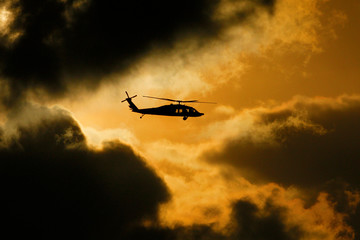 a combat helicopter performs maneuvers in the air