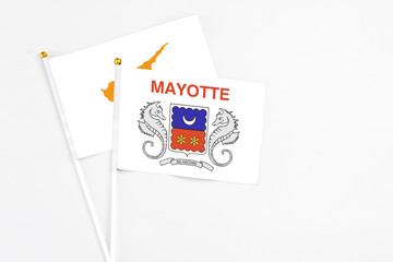 Mayotte and Cyprus stick flags on white background. High quality fabric, miniature national flag. Peaceful global concept.White floor for copy space.