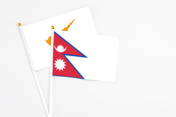 Nepal and Cyprus stick flags on white background. High quality fabric, miniature national flag. Peaceful global concept.White floor for copy space.