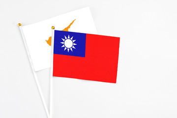 Taiwan and Cyprus stick flags on white background. High quality fabric, miniature national flag. Peaceful global concept.White floor for copy space.