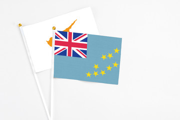 Tuvalu and Cyprus stick flags on white background. High quality fabric, miniature national flag....