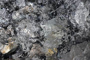 Sea surf washes coastal stones. Abstract photo. Can be used as background photo