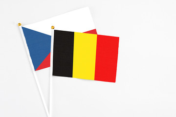 Belgium and Cyprus stick flags on white background. High quality fabric, miniature national flag. Peaceful global concept.White floor for copy space.