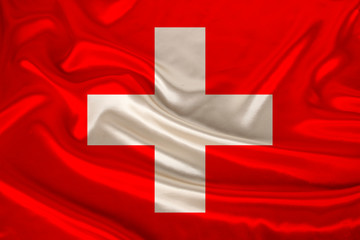 photo of the national flag of Switzerland on a luxurious texture of satin, silk with waves, folds and highlights, closeup, copy space, travel concept, economy and state policy, illustration