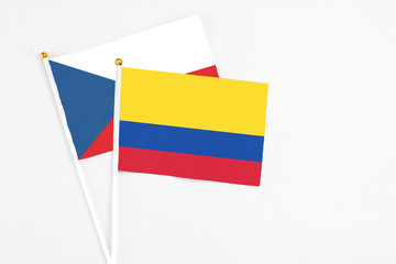 Colombia and Cyprus stick flags on white background. High quality fabric, miniature national flag. Peaceful global concept.White floor for copy space.