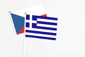 Greece and Cyprus stick flags on white background. High quality fabric, miniature national flag. Peaceful global concept.White floor for copy space.