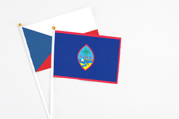 Guam and Cyprus stick flags on white background. High quality fabric, miniature national flag. Peaceful global concept.White floor for copy space.