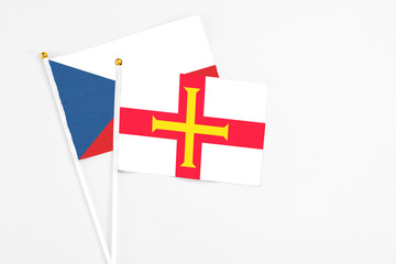 Guernsey and Cyprus stick flags on white background. High quality fabric, miniature national flag. Peaceful global concept.White floor for copy space.