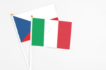 Fototapeta premium Italy and Cyprus stick flags on white background. High quality fabric, miniature national flag. Peaceful global concept.White floor for copy space.