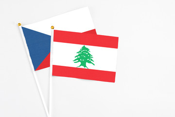Lebanon and Cyprus stick flags on white background. High quality fabric, miniature national flag. Peaceful global concept.White floor for copy space.