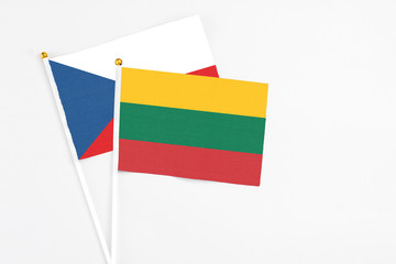 Lithuania and Cyprus stick flags on white background. High quality fabric, miniature national flag. Peaceful global concept.White floor for copy space.
