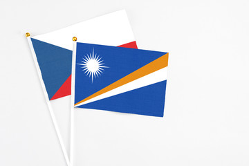 Marshall Islands and Cyprus stick flags on white background. High quality fabric, miniature national flag. Peaceful global concept.White floor for copy space.