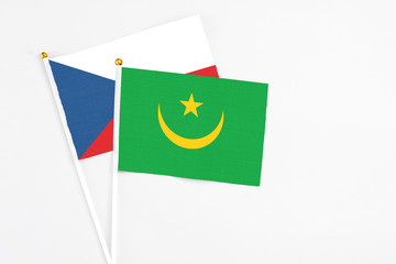 Mauritania and Cyprus stick flags on white background. High quality fabric, miniature national flag. Peaceful global concept.White floor for copy space.