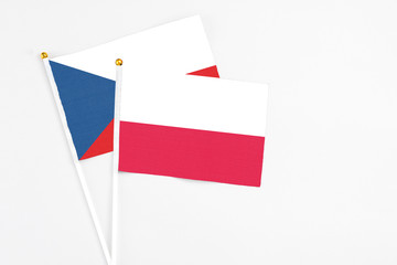 Poland and Cyprus stick flags on white background. High quality fabric, miniature national flag. Peaceful global concept.White floor for copy space.