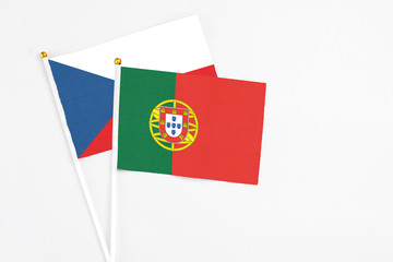 Portugal and Cyprus stick flags on white background. High quality fabric, miniature national flag. Peaceful global concept.White floor for copy space.