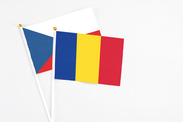 Romania and Cyprus stick flags on white background. High quality fabric, miniature national flag. Peaceful global concept.White floor for copy space.
