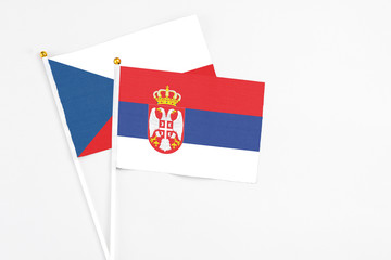 Serbia and Cyprus stick flags on white background. High quality fabric, miniature national flag. Peaceful global concept.White floor for copy space.