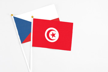 Tunisia and Cyprus stick flags on white background. High quality fabric, miniature national flag. Peaceful global concept.White floor for copy space.