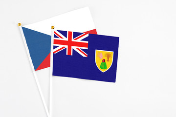 Turks And Caicos Islands and Cyprus stick flags on white background. High quality fabric, miniature national flag. Peaceful global concept.White floor for copy space.