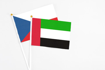 United Arab Emirates and Cyprus stick flags on white background. High quality fabric, miniature national flag. Peaceful global concept.White floor for copy space.