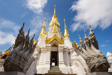 Fototapeta premium Golden and white pagoda at Wat Tham Khuha Sawan Temple, Ubon Ratchathani province, Thailand