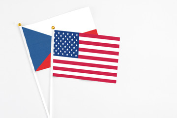 United States and Cyprus stick flags on white background. High quality fabric, miniature national flag. Peaceful global concept.White floor for copy space.