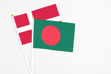 Bangladesh and Denmark stick flags on white background. High quality fabric, miniature national flag. Peaceful global concept.White floor for copy space.