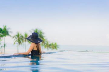 Portrait beautiful young asian women happy smile relax outdoor swimming pool in hotel