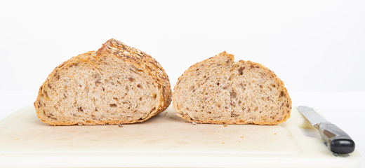 Close up of a sliced loaf of whole grain bread with a shallow depth of field