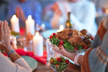 Beautiful family smiling happy and confident. Showing roasted turkey and applauding celebrating Thanksgiving Day at home