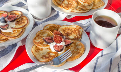Breakfast of delicious homemade pancakes with fresh figs and tea