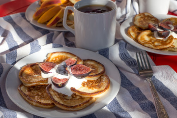 Breakfast of delicious homemade pancakes with fresh figs and tea