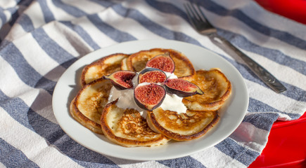 Breakfast of delicious homemade pancakes with fresh figs and tea