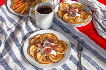 Breakfast of delicious homemade pancakes with fresh figs and tea