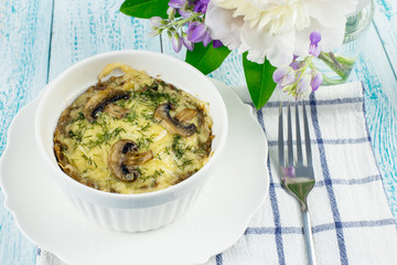 Delicious buckwheat casserole with mushrooms and cheese. Health food. Healthy Breakfast of buckwheat and milk.