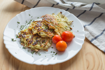 Potato pancakes on a blue plate. Russian national dish.