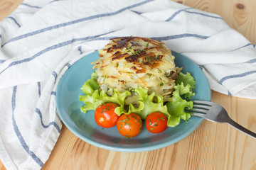 Potato pancakes on a blue plate. Russian national dish.