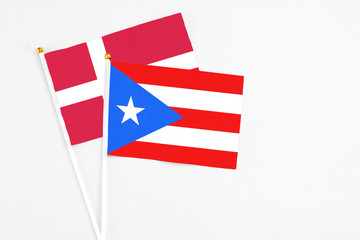 Puerto Rico and Denmark stick flags on white background. High quality fabric, miniature national flag. Peaceful global concept.White floor for copy space.