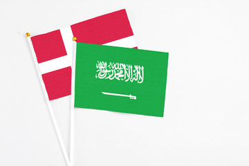 Saudi Arabia and Denmark stick flags on white background. High quality fabric, miniature national flag. Peaceful global concept.White floor for copy space.