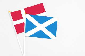 Scotland and Denmark stick flags on white background. High quality fabric, miniature national flag. Peaceful global concept.White floor for copy space.
