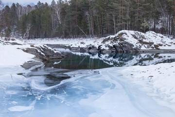 The blue ice of the mountain river Katun in the winter. Landscape with river and mountains in Altai. Siberia. Altai. Russia.