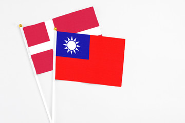 Taiwan and Denmark stick flags on white background. High quality fabric, miniature national flag. Peaceful global concept.White floor for copy space.