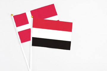 Yemen and Denmark stick flags on white background. High quality fabric, miniature national flag. Peaceful global concept.White floor for copy space.