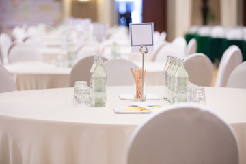 Selective focus of Paper, pencil, water bottle, glass  on the table in the seminar room background