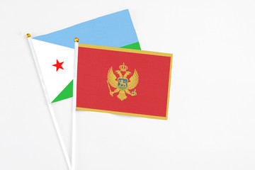 Montenegro and Djibouti stick flags on white background. High quality fabric, miniature national flag. Peaceful global concept.White floor for copy space.