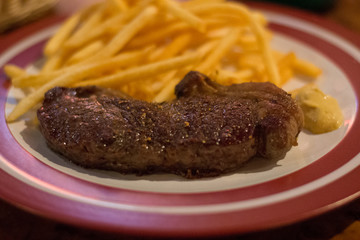 Ribeye Steak with a red wine sauce served with mash and veggies