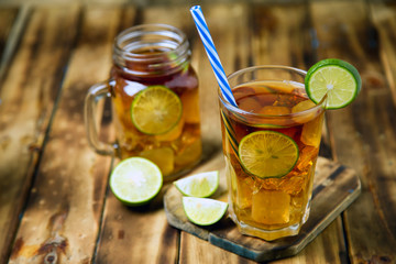 iced tea cocktail with strong drinks, wood background