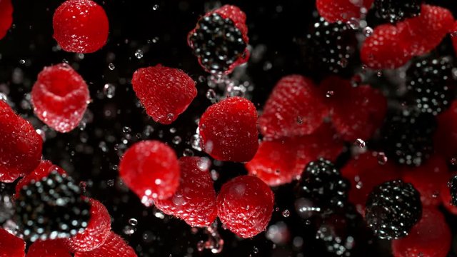 Super slow motion of berries fruit with splashing water, black background. Filmed on high speed cinema camera, 1000 fps.