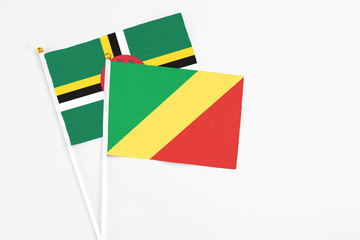 Republic Of The Congo and Dominica stick flags on white background. High quality fabric, miniature national flag. Peaceful global concept.White floor for copy space.