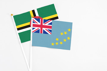 Tuvalu and Dominica stick flags on white background. High quality fabric, miniature national flag. Peaceful global concept.White floor for copy space.